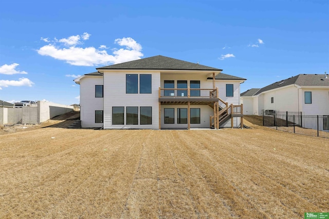 rear view of property with stairway, a lawn, a fenced backyard, and roof with shingles