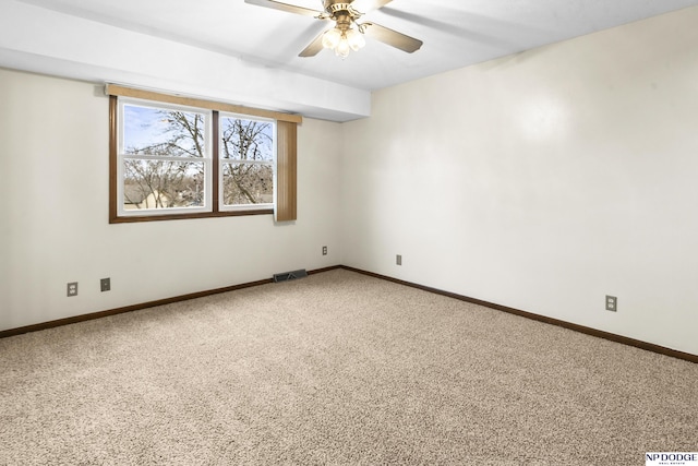 empty room featuring visible vents, baseboards, a ceiling fan, and carpet flooring