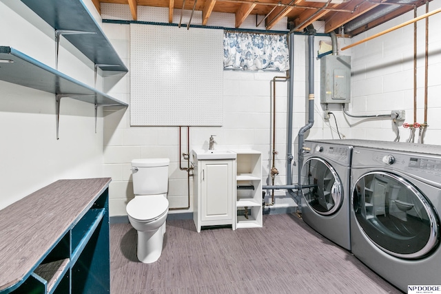 laundry area featuring laundry area, electric panel, and separate washer and dryer