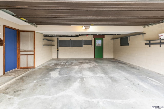 garage with concrete block wall