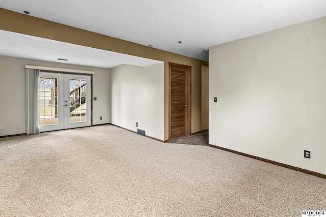 unfurnished room featuring french doors, baseboards, and carpet floors