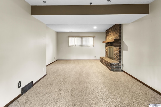 unfurnished living room with visible vents, baseboards, carpet flooring, and a fireplace