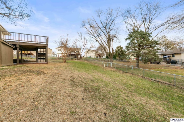 view of yard featuring stairs, a deck, and fence