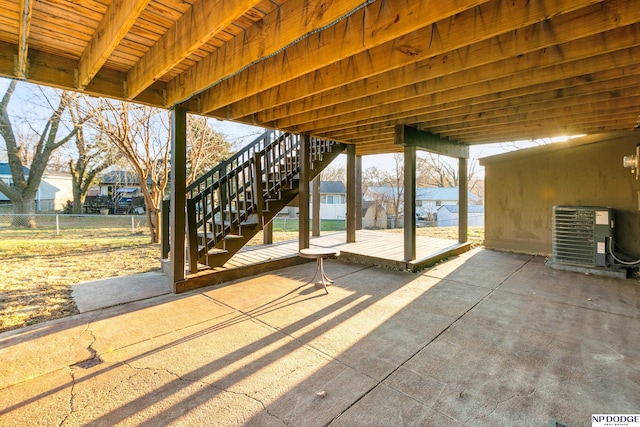 view of patio / terrace with cooling unit, a residential view, fence, and stairway