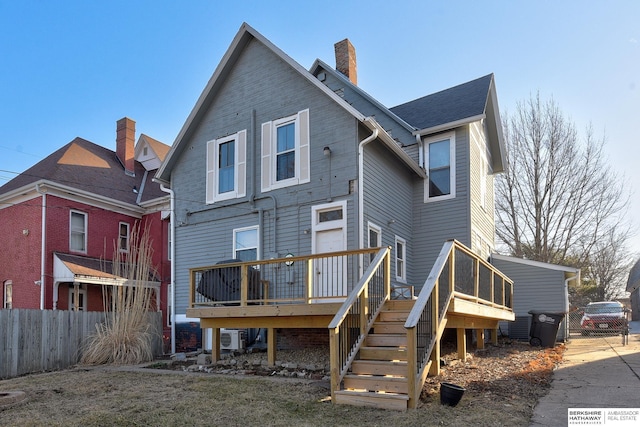 rear view of house featuring stairway, fence, a wooden deck, a chimney, and ac unit