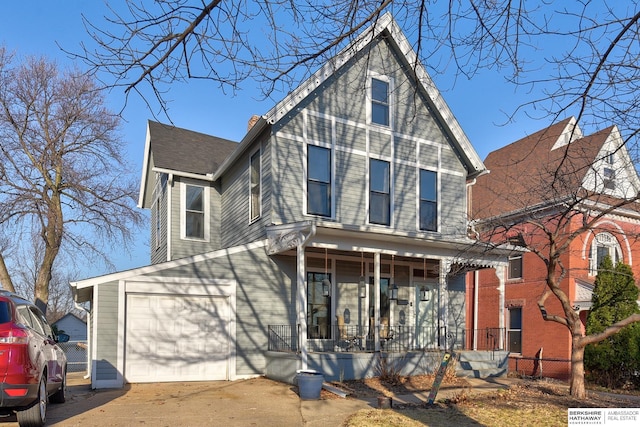 view of front of property featuring covered porch, a garage, and fence