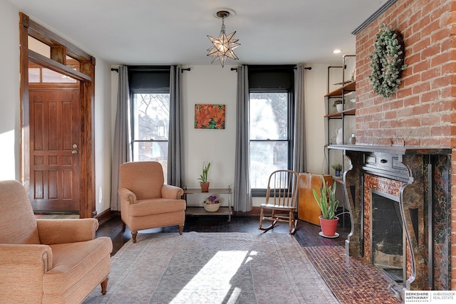 sitting room featuring a brick fireplace