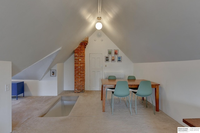 interior space with vaulted ceiling and carpet flooring