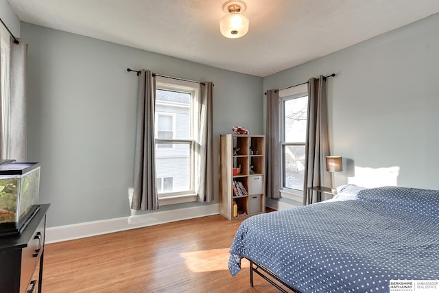 bedroom featuring light wood-style flooring and baseboards