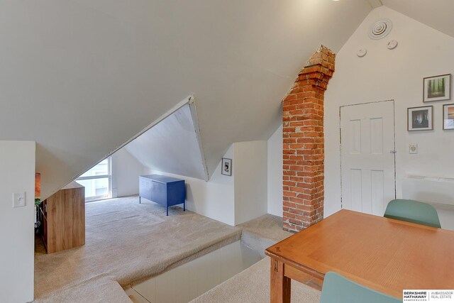 bonus room with carpet and vaulted ceiling