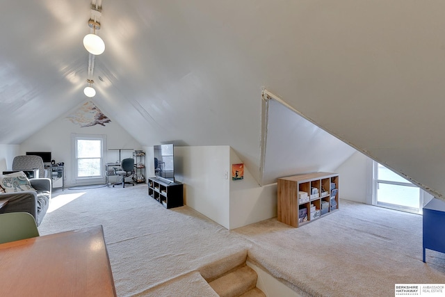 living area with lofted ceiling and carpet