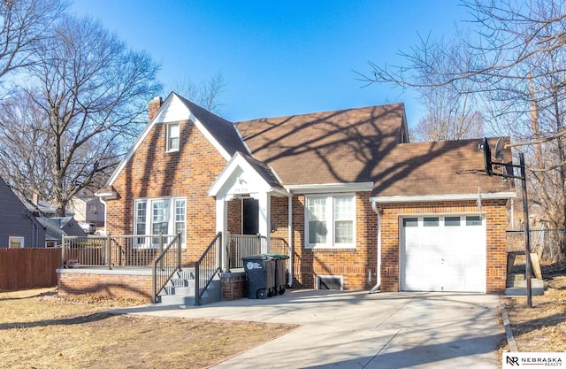 view of front of house with brick siding, fence, concrete driveway, a chimney, and a garage