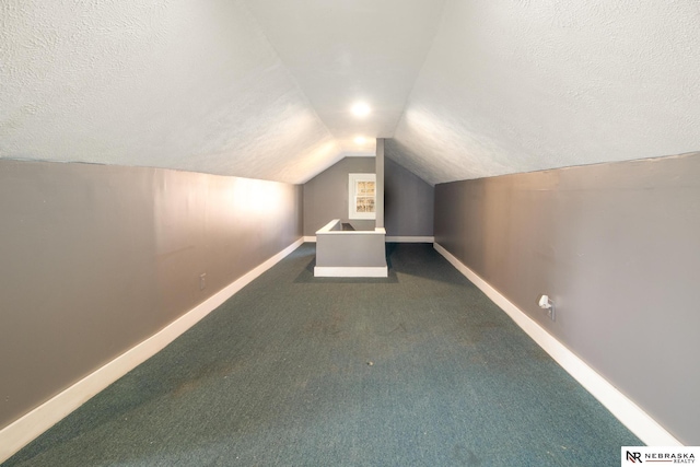 bonus room with baseboards, a textured ceiling, lofted ceiling, and carpet flooring