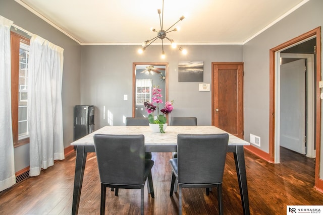 dining area featuring visible vents, an inviting chandelier, dark wood-style floors, and crown molding