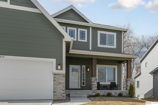 craftsman-style home with a porch, a garage, and stone siding