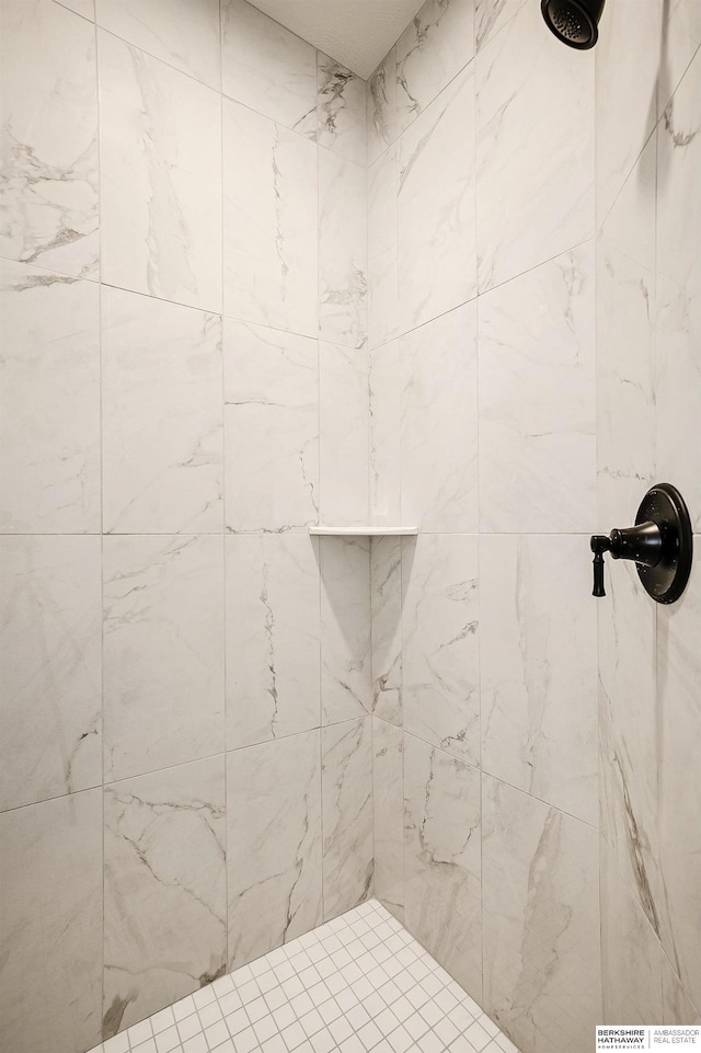 bathroom with a tile shower