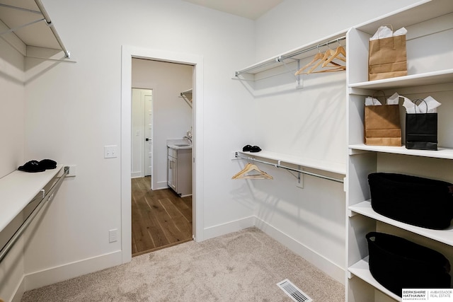 walk in closet featuring carpet flooring and visible vents