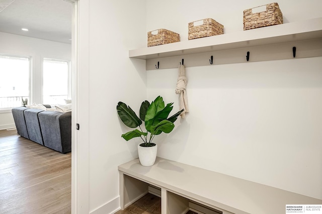 mudroom featuring recessed lighting, baseboards, and light wood-style floors