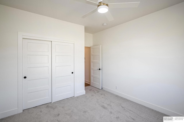 unfurnished bedroom with a closet, a ceiling fan, baseboards, and carpet floors
