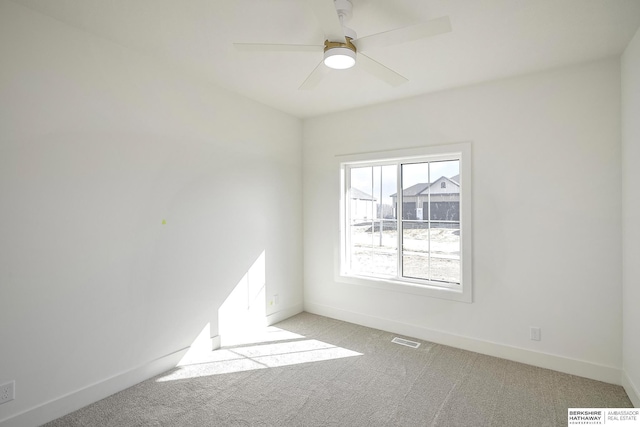 unfurnished room featuring visible vents, baseboards, light colored carpet, and ceiling fan