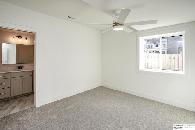 unfurnished bedroom featuring light colored carpet, visible vents, and baseboards