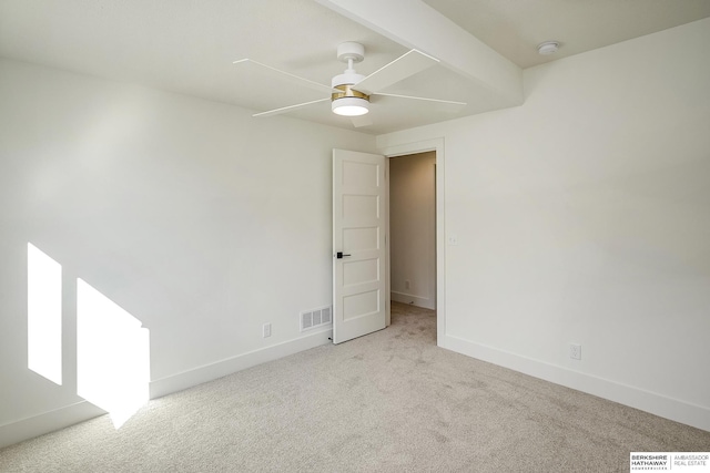 empty room with visible vents, baseboards, carpet, and a ceiling fan
