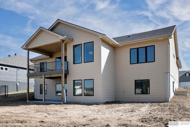 rear view of property with a balcony and a patio area
