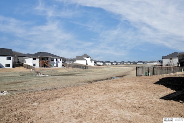 view of yard with a residential view and fence