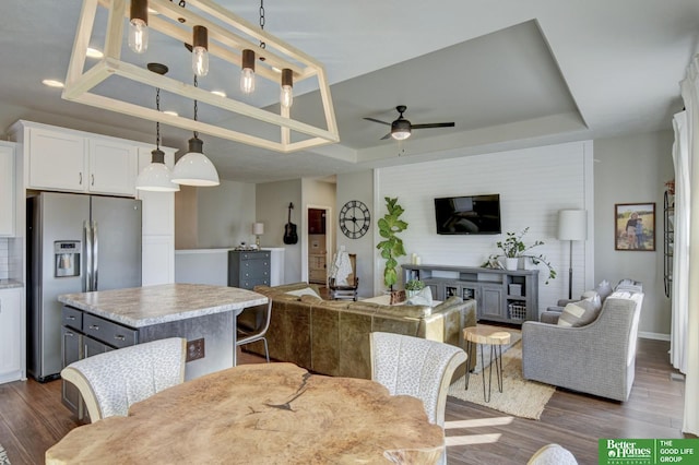 kitchen featuring a tray ceiling, a ceiling fan, open floor plan, and stainless steel refrigerator with ice dispenser