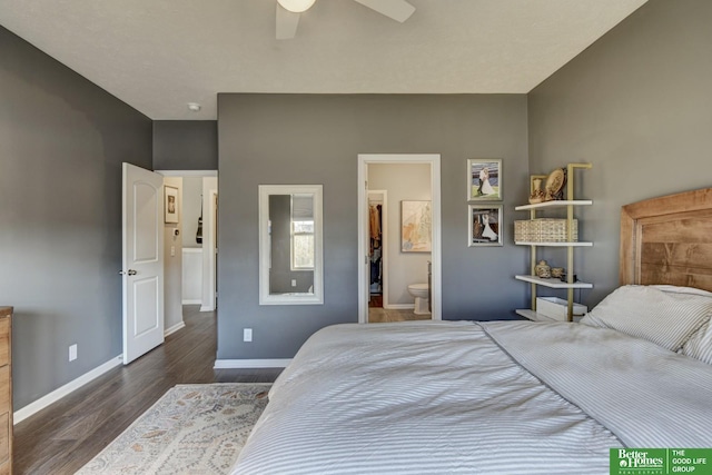 bedroom featuring dark wood-style floors, connected bathroom, a ceiling fan, and baseboards