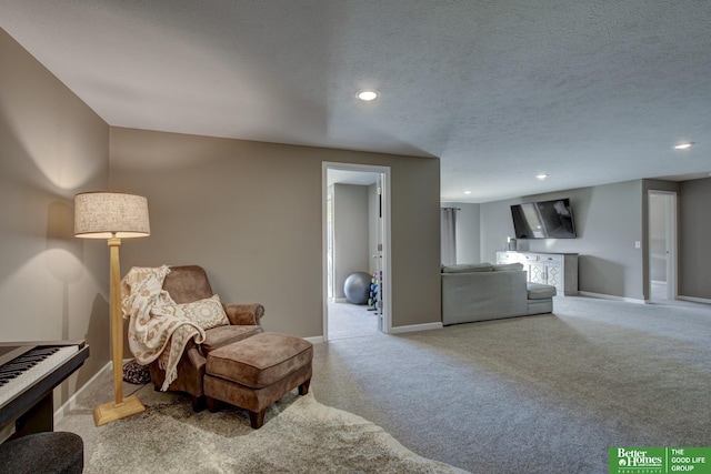 sitting room with recessed lighting, baseboards, a textured ceiling, and carpet floors