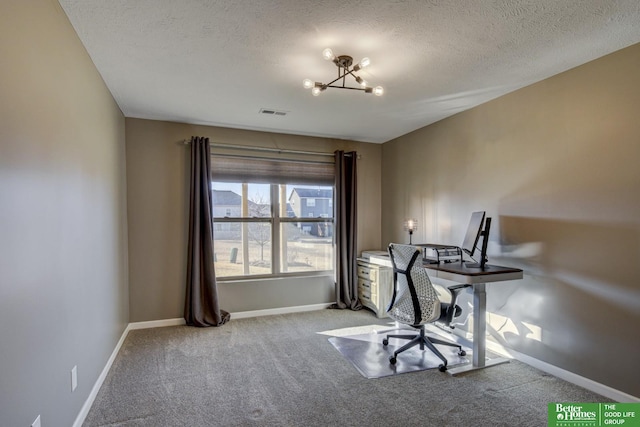 unfurnished office with visible vents, baseboards, carpet flooring, a notable chandelier, and a textured ceiling