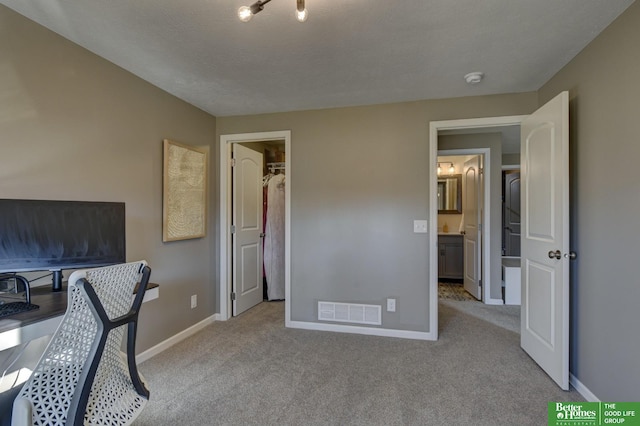 office area featuring visible vents, carpet, and baseboards