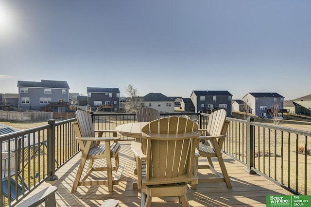 wooden deck featuring outdoor dining space and a residential view