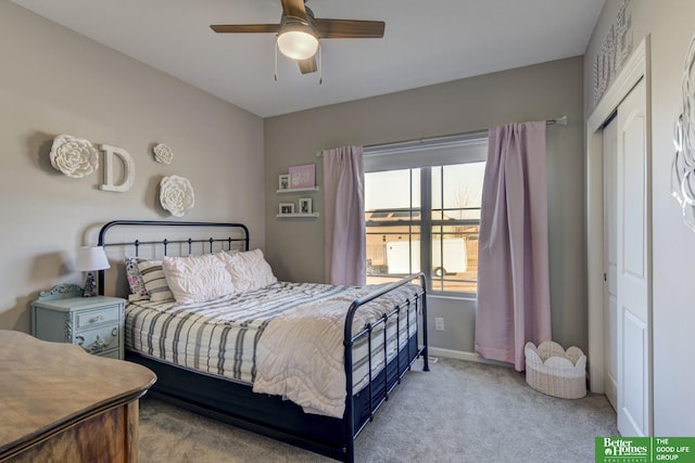 carpeted bedroom with a ceiling fan, a closet, and baseboards