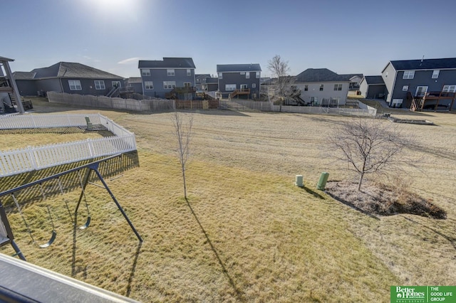 view of yard with a residential view and fence