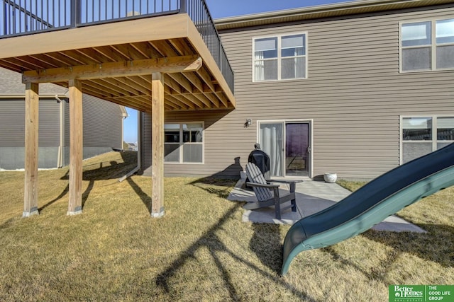 back of house featuring a patio area and a lawn