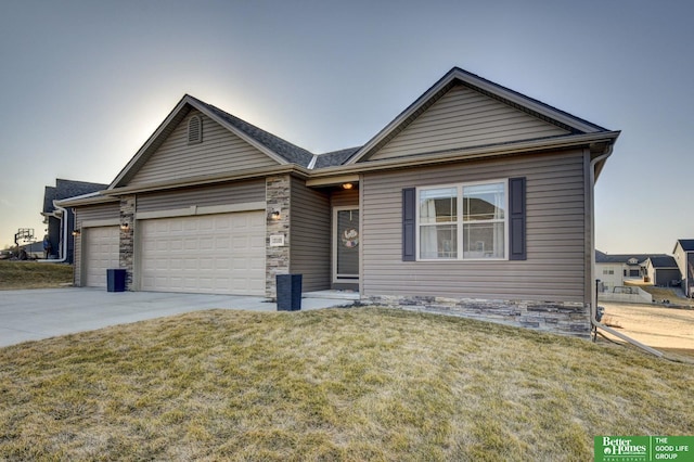 ranch-style house featuring stone siding, a front lawn, concrete driveway, and an attached garage