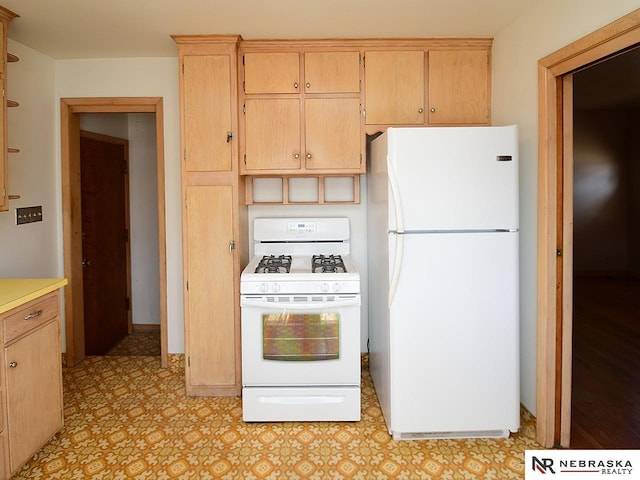 kitchen with white appliances, light floors, and light countertops