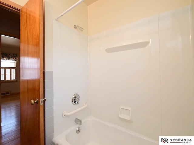 full bath with visible vents and tub / shower combination