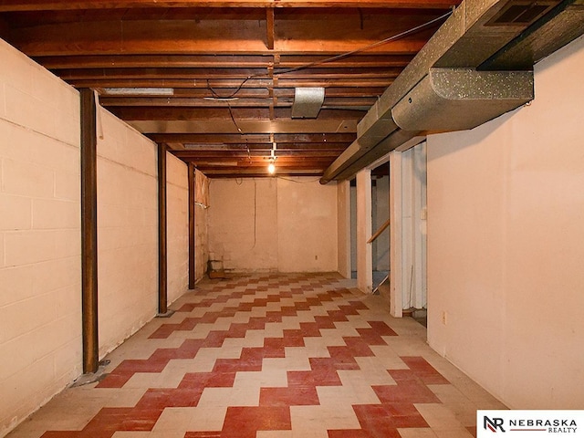 basement featuring visible vents and stairs