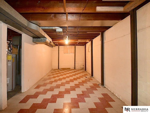 basement with water heater and light floors