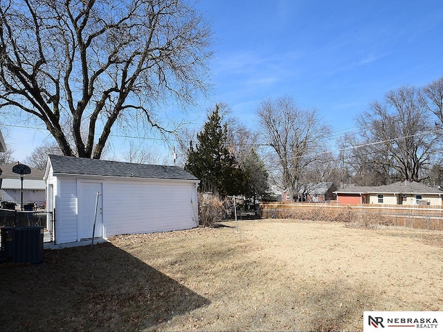 view of yard featuring cooling unit, an outdoor structure, and fence