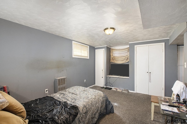 bedroom with a closet, carpet floors, and a textured ceiling