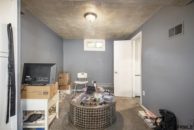 interior space with visible vents, carpet floors, and a textured ceiling