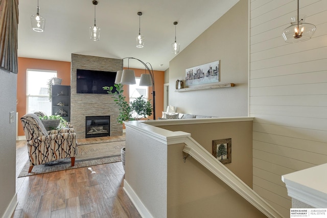 interior space with baseboards, high vaulted ceiling, and wood finished floors