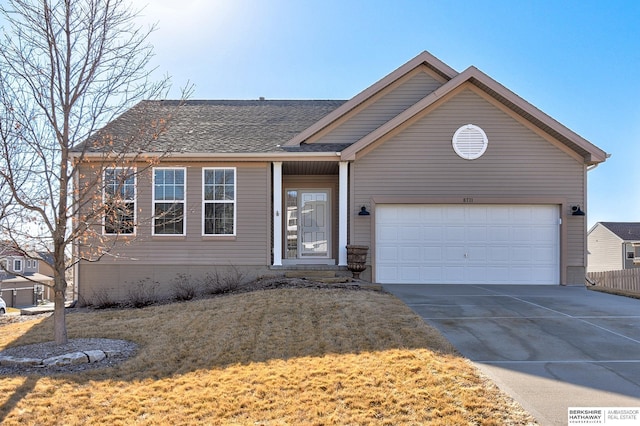 ranch-style home with driveway, a front lawn, an attached garage, and a shingled roof