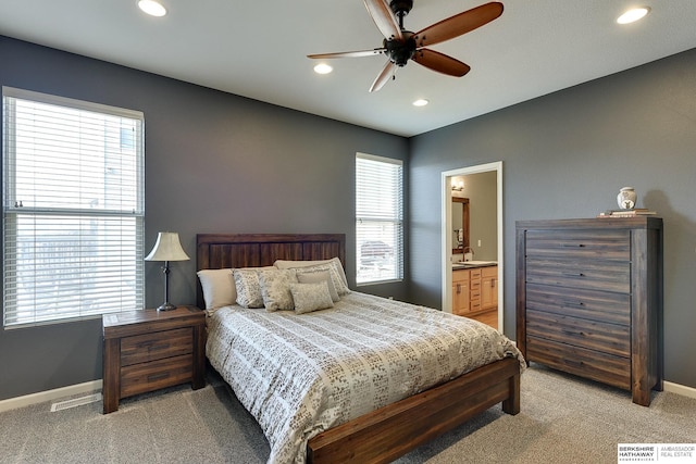 bedroom with recessed lighting, light colored carpet, and baseboards