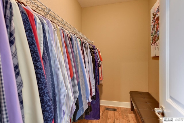 walk in closet featuring wood finished floors and visible vents