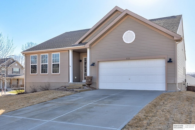 ranch-style home featuring an attached garage, driveway, and roof with shingles